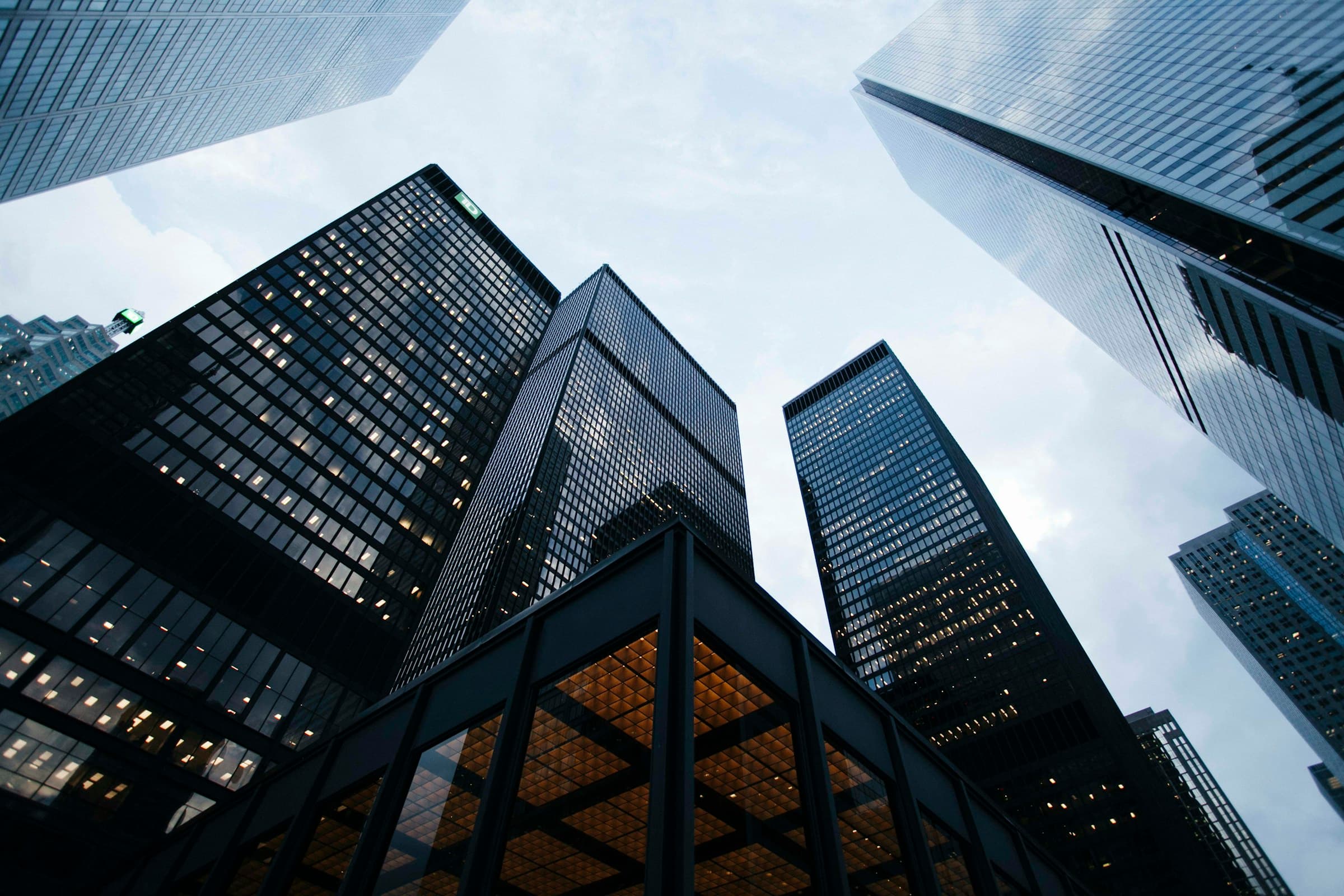 Glass towers rising against an overcast sky